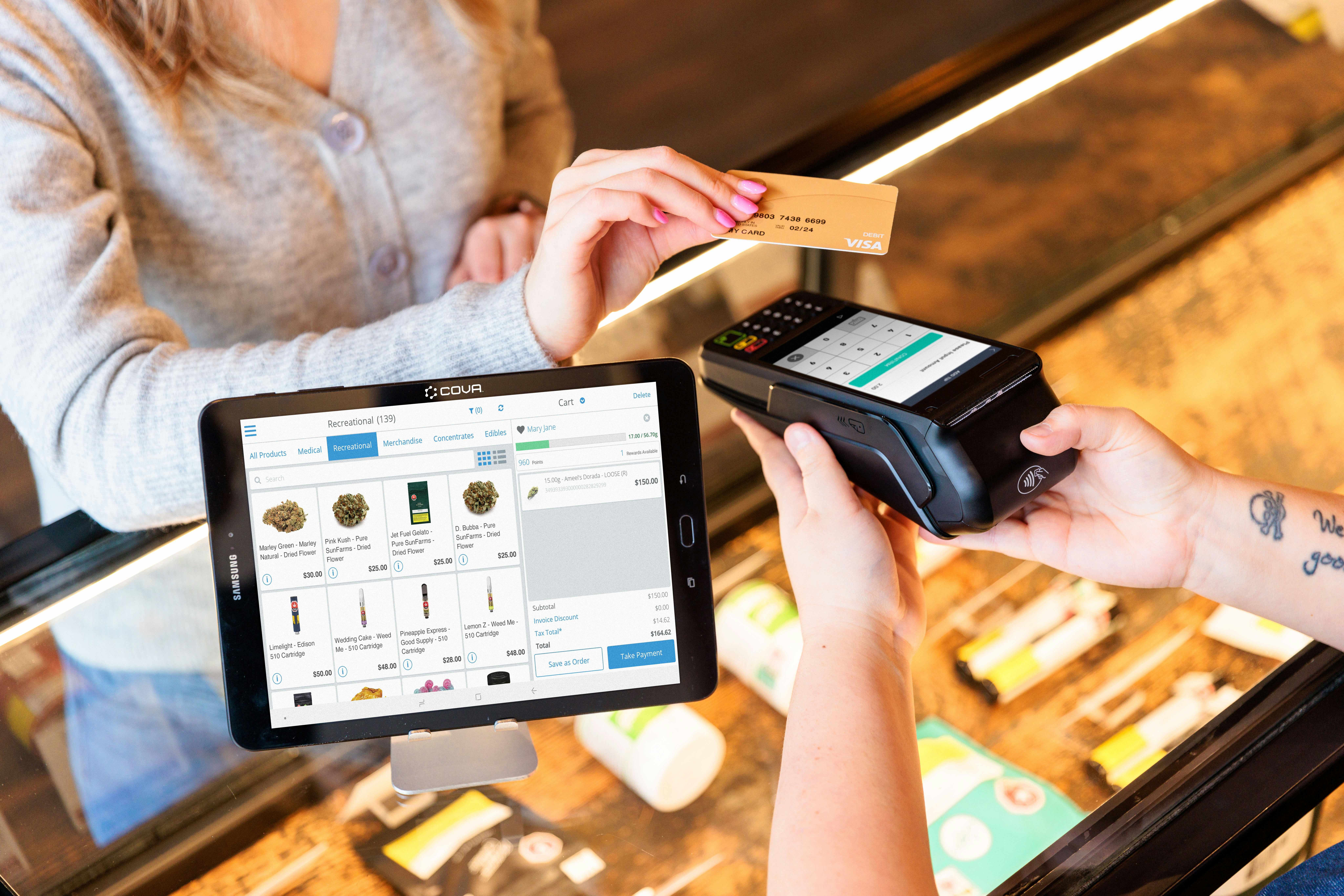 a woman is paying a card from a machine